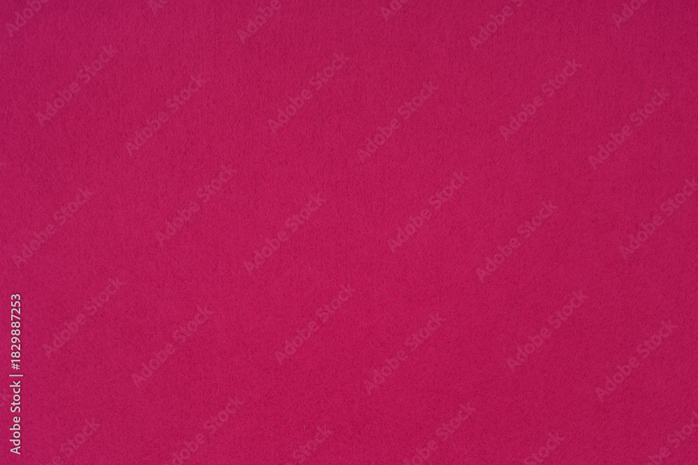 Fototapeta premium Crimson, bright pink felt background - close-up of the soft surface of the fabric. Seamless background, graphic design, scrapbooking, textile layouts, creative projects.