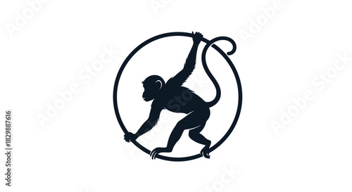 A dark silhouette of an agile monkey hanging and balancing playfully on a circular ring, symbolizing wild nature and movement.