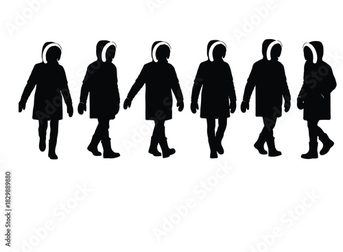 Silhouettes of people in hooded parkas walking group