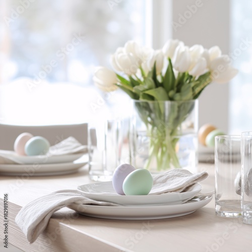 A table set with a white plate and two blue Easter eggs.