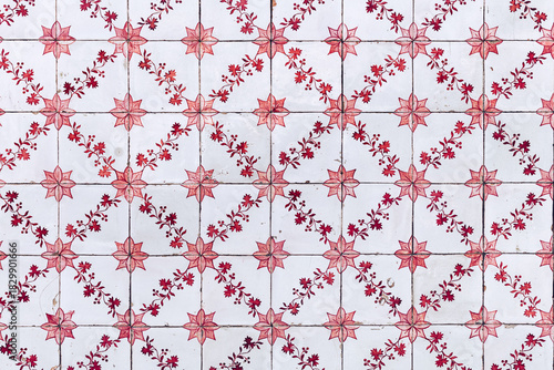 Typical old red and white azulejos at exterior wall of  residential building in Portugal.