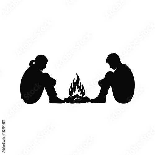 Two people sitting by a campfire silhouette