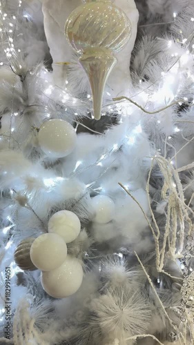 4k footage close up of lighted Christmas tree ornaments and decorations. Mistletoe, baubles, and bell with Interactive sparkling christmas twinkle lights or icicle lights.