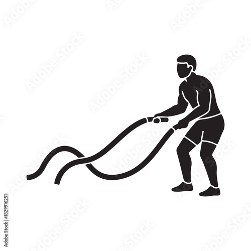 Male athlete performing battle rope exercise for strength training