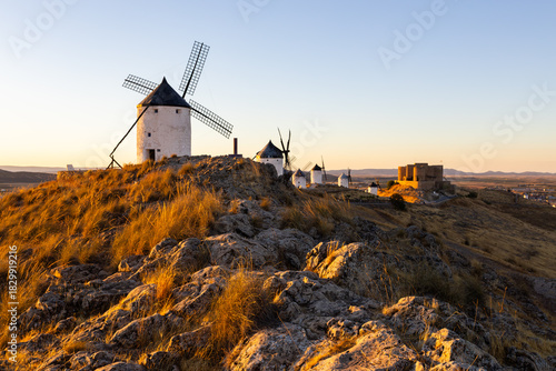 Consuegra windmills and castle at sunset in La Mancha