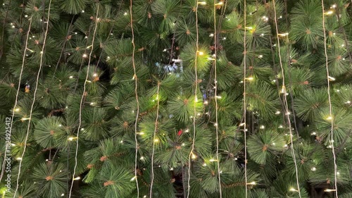 4k footage close up of icicle lights on christmas tree with interactive sparkling lights. Interactive sparkling christmas twinkle lights or icicle lights. Seasons greetings, merry christmas.