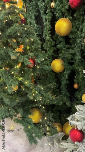 4k footage close up of lighted Christmas tree ornaments and decorations. Snow, mistletoe, baubles, and bell with Interactive sparkling christmas twinkle lights or icicle lights.