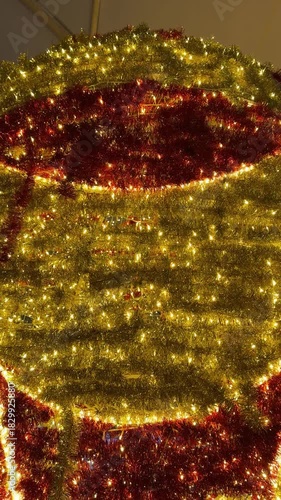 Footage of sparkling christmas tinsels arrangement background, illuminated with twinkle icicle lights. tinsels garland in gold and red colors. Christmas festive decoration. Merry Christmas