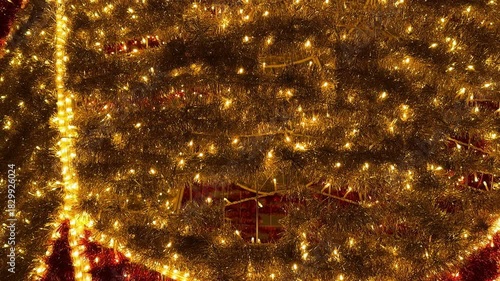 Footage of sparkling christmas tinsels arrangement background, illuminated with twinkle icicle lights. tinsels garland in gold and red colors. Christmas festive decoration. Merry Christmas