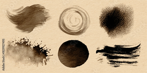 Collection of abstract brown and black ink brush strokes and smudges on a textured beige background