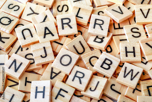 Alphabet letters on wooden block pieces, from above.Close up of Wooden letter cubes.Challenge and solution concept.Hobbies and leisure activities