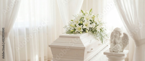 Serene white casket adorned with flowers in a peaceful setting  