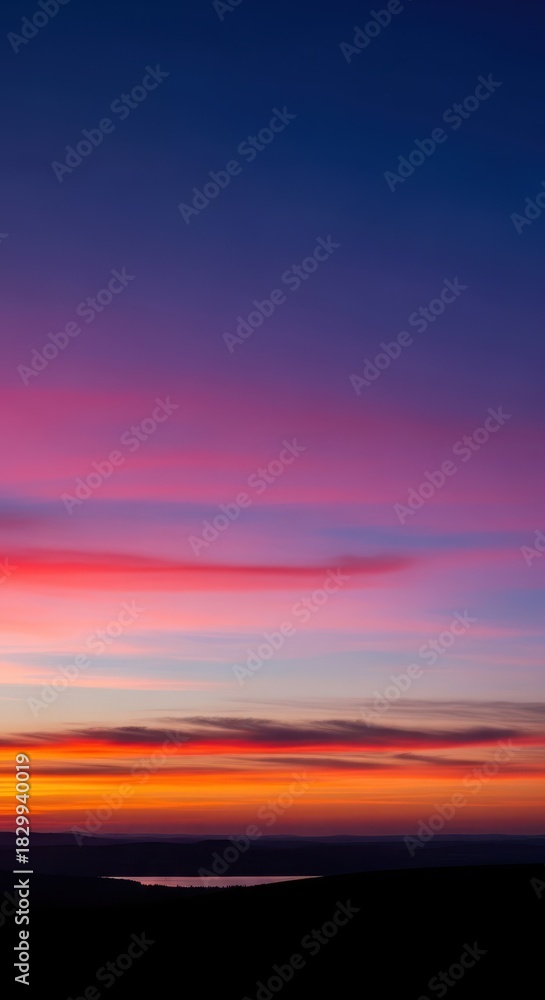 Obraz premium Serene panoramic view captured during the last minutes of twilight, showcasing deep atmospheric color gradients across the vast horizon, wide, outdoor, sky