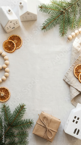 Christmas still life with ceramic houses, dried oranges, and a wrapped gift, Mobile orientation
