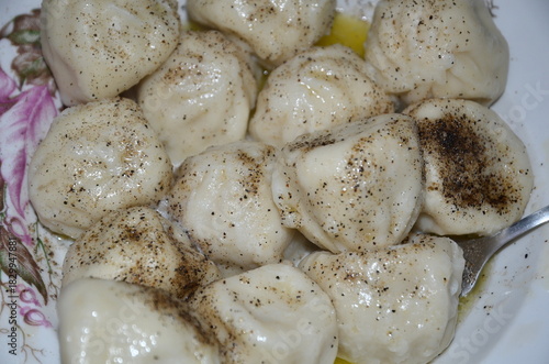 Khinkali sprinkled with ground pepper.