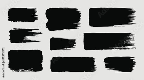 A collection of black brush strokes of varying sizes and shapes on a light gray background design element