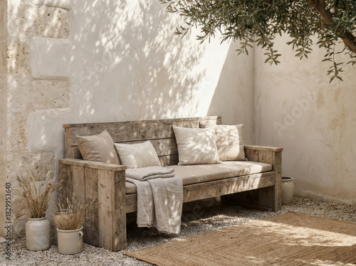 Rustic wooden bench with cushions in a sunlit outdoor courtyard setting