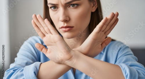 Close-up on a mature female's hand making a definitive disagree gesture. This body language signals refusal and dislike, capturing a moment of negative communication