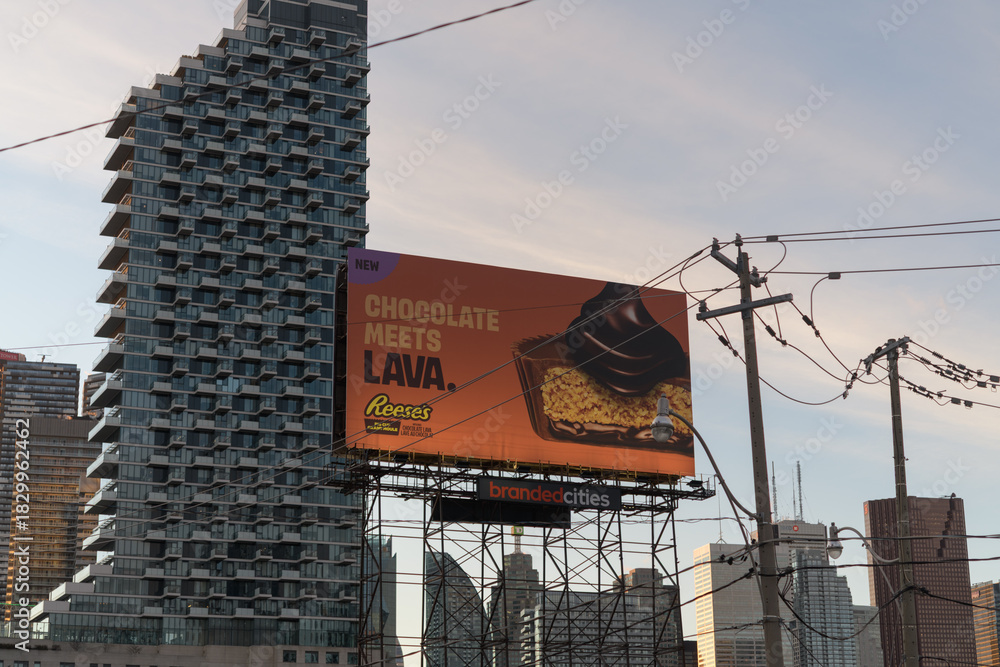Fototapeta premium Monde Condominiums and road side billboard for Reece candy, looking west on Queens Quay E, Toronto