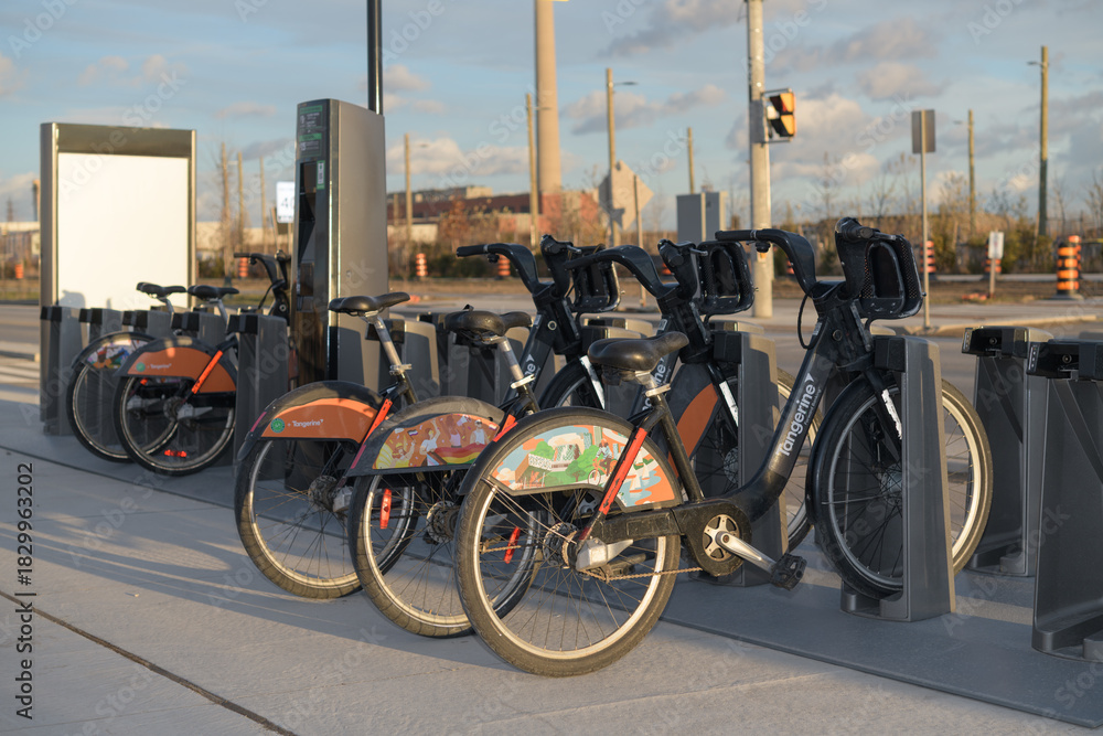 Obraz premium bike rental docking station with vehicles, Toronto