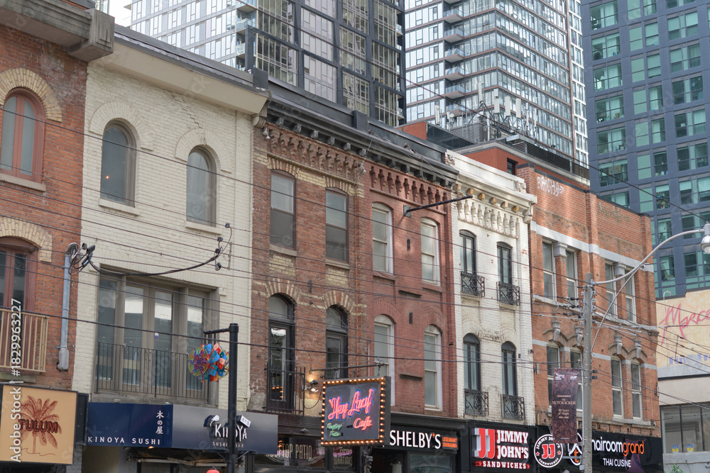 Fototapeta premium contrast of architecture on King St W, Toronto (shop fronts)