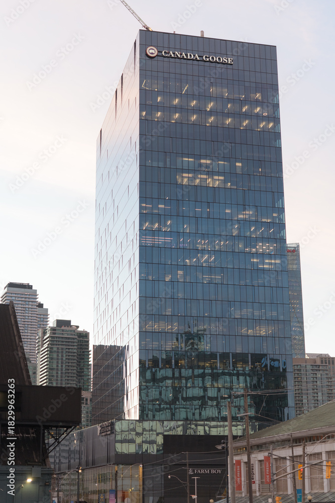 Obraz premium exterior building elevation and sign of Canada Goose corporate office located at 100 Queens Quay E, dusk, Toronto