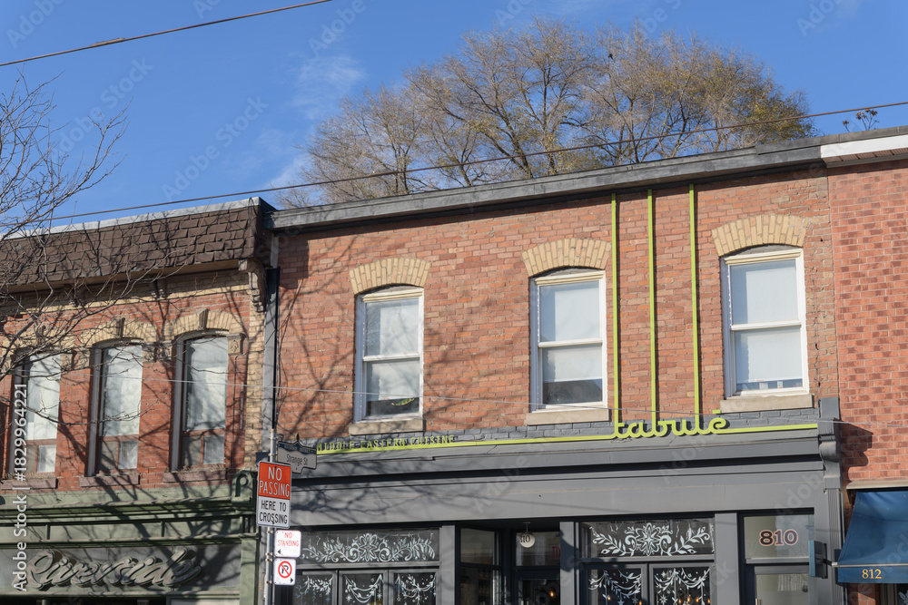 Obraz premium exterior building facade and sign of Tabule, a Middle Eastern restaurant, located at 810 Queen St E, Toronto