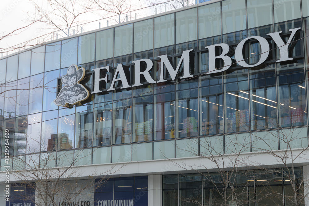 Fototapeta premium exterior building facade and sign of Farm Boy, a fresh food market, located here at 100 Queens Quay E, Sugar Wharf Condominiums, Toronto