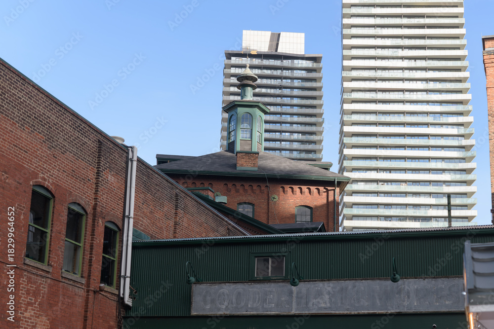 Obraz premium contrast of architecture at Gooderham & Worts Limited distillery, or the Distillery District, Toronto