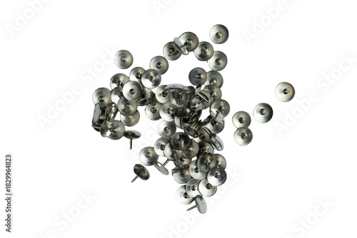 Scattered metal thumb tacks on transparent background
