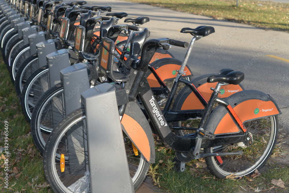 Fototapeta premium bike rental docking station with vehicles, Toronto - Lake Shore Blvd E near Leslie St