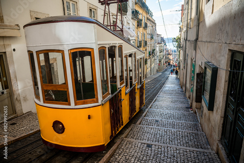 Yellow funicular tram car of the Elevador da Bica in Lisbon, Portugal