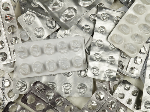 Heap of empty pill blister packs, top view. Treatment and medication concept
