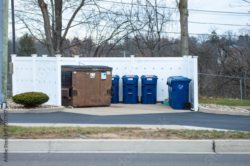 Εκτύπωση καμβά Commercial Waste Management Area with Brown Dumpster and Blue Recycling Bins in