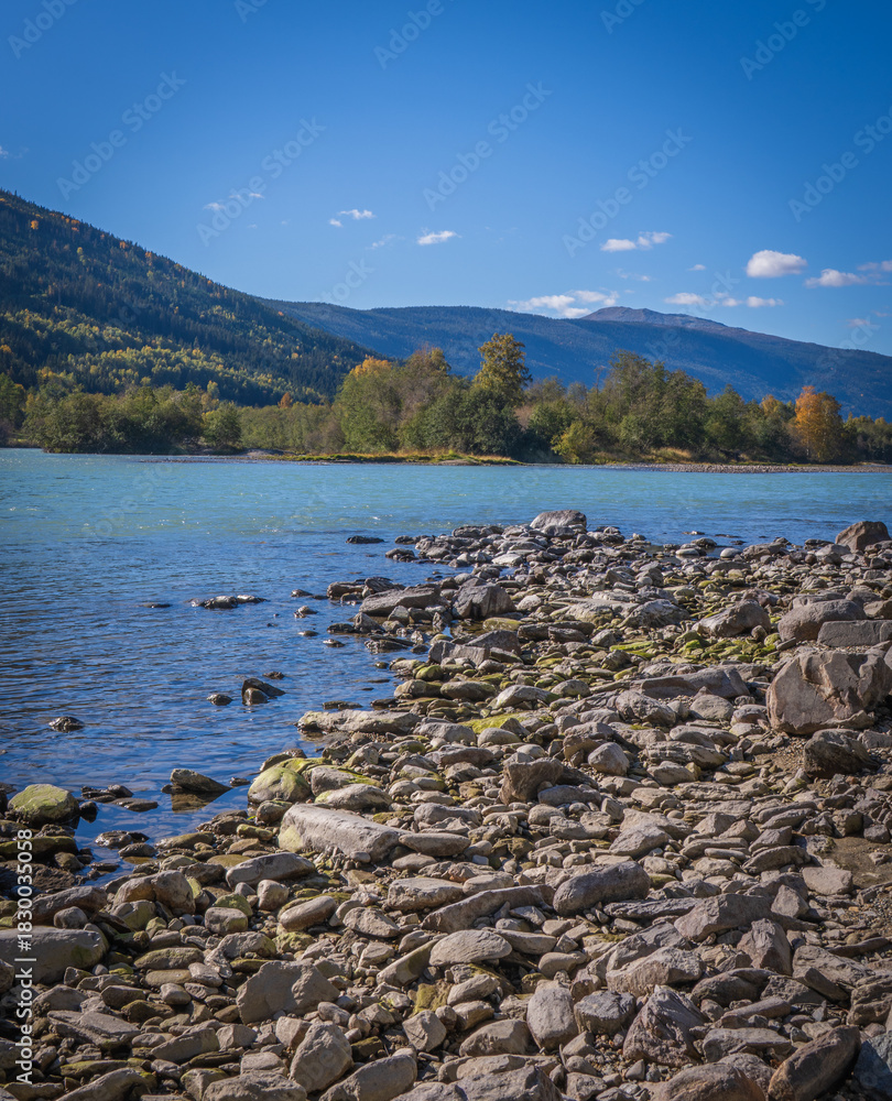 Fototapeta premium Scenic turquoise Lågen River with forested mountains in Norwegian Gudbrandsdalen valley