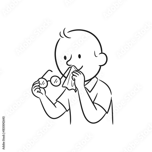Boy cleaning glasses with tissue and holding them in his hand  
