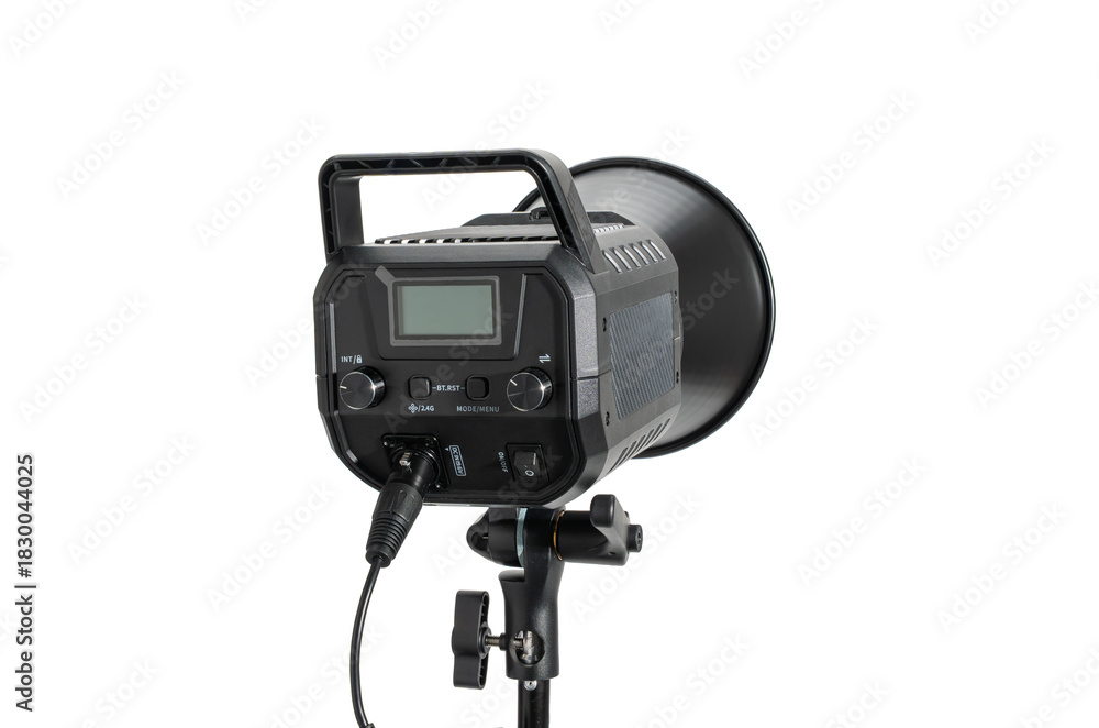 Naklejka premium Rear view of a studio light head on a stand, isolated on white. Control panel housing with handle and attached power cable for photographic lighting.