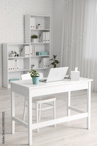 Doctor's workplace with laptop in modern clinic