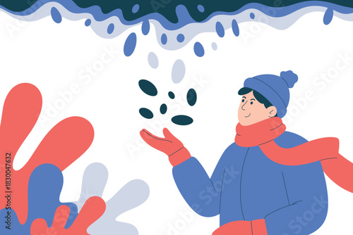 A person in winter clothing catches falling snow or ice pellets in their hand.