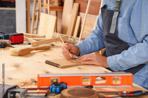 Mature carpenter drawing on...