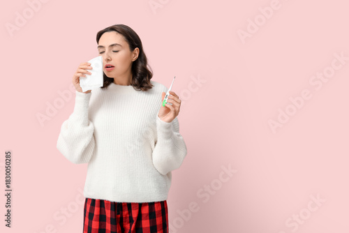 Sick young woman with therm...