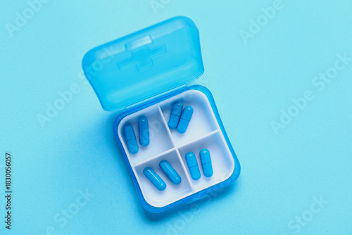 Container with pills on blu...