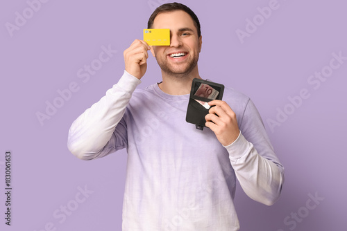 Young happy man holding wal...
