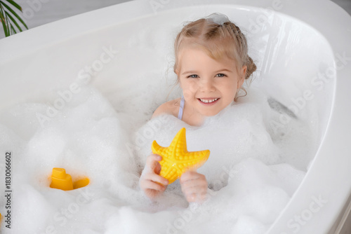 Cute little girl with toys ...