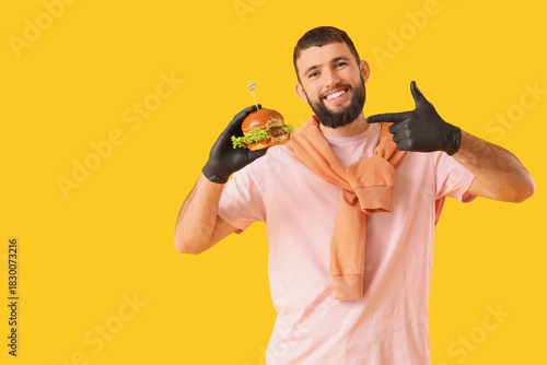 Young man in black gloves p...