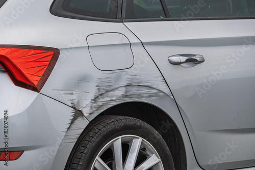 Car after accident. Damaged rear wing of a gray car