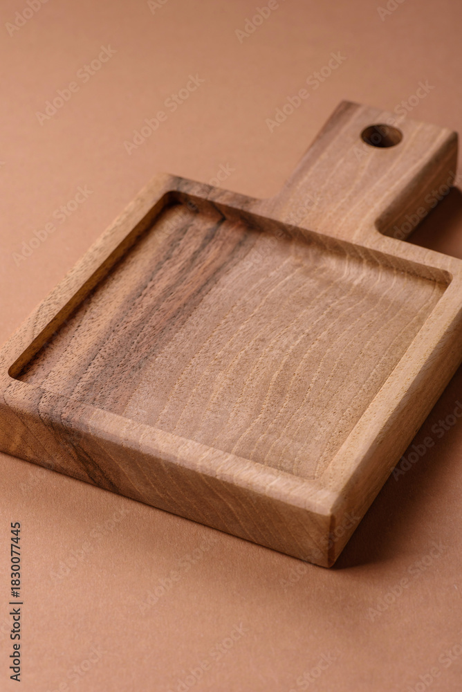 Fototapeta premium Wood, a wooden empty cutting board on a dark kitchen table. Wooden cutting board