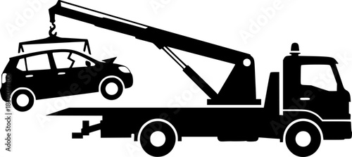Silhouette of a tow truck lifting a broken down car with its crane
