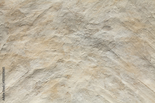 White, yellowed uneven (relief) surface. Chalked surface, background, texture. Clay bumpy surface, covered with lime or chalk. Old natural ecological coating in residential construction. Natural cover