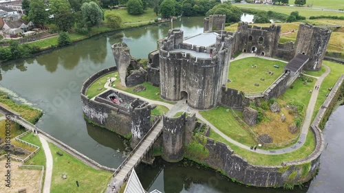 Aerial drone footage orbiting the large medieval Caerphilly Castle in Wales